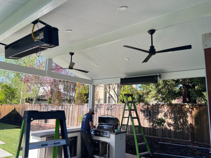 Finished Danville covered patio ceiling with fans recessed lighting and heaters.