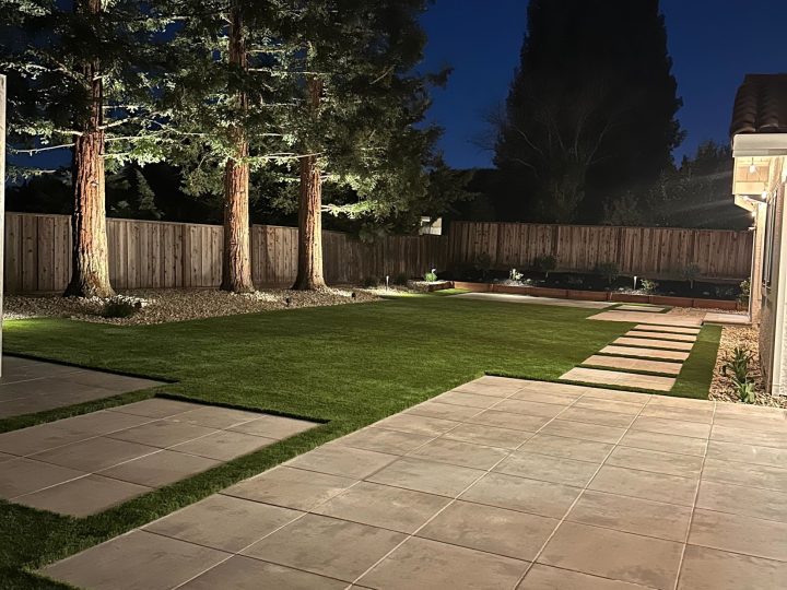 Finished paver walkway and landscaped lawn at dusk in the Danville patio cover project.