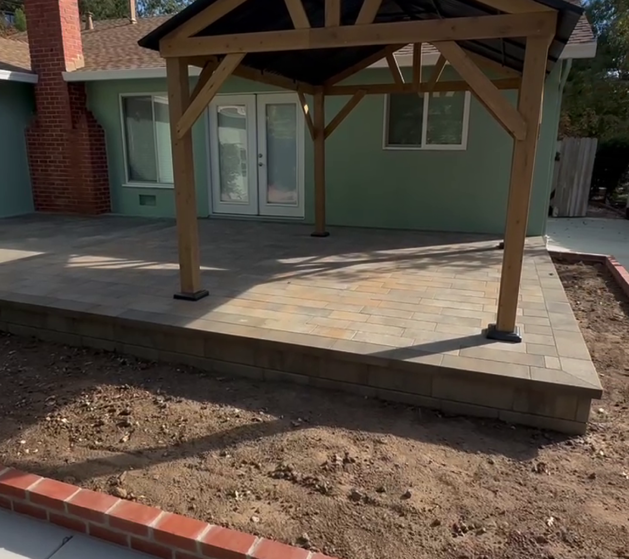 Wood gable patio cover over a raised paver patio in Martinez by FG Pavers and Turf.