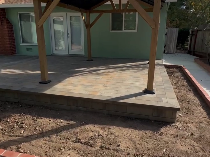 Centered view of a wood gable patio cover over a Martinez paver patio by FG Pavers and Turf.