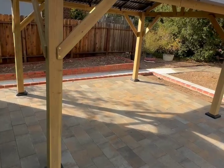 Wood gable patio cover roof and post detail above a Martinez paver patio by FG Pavers and Turf.