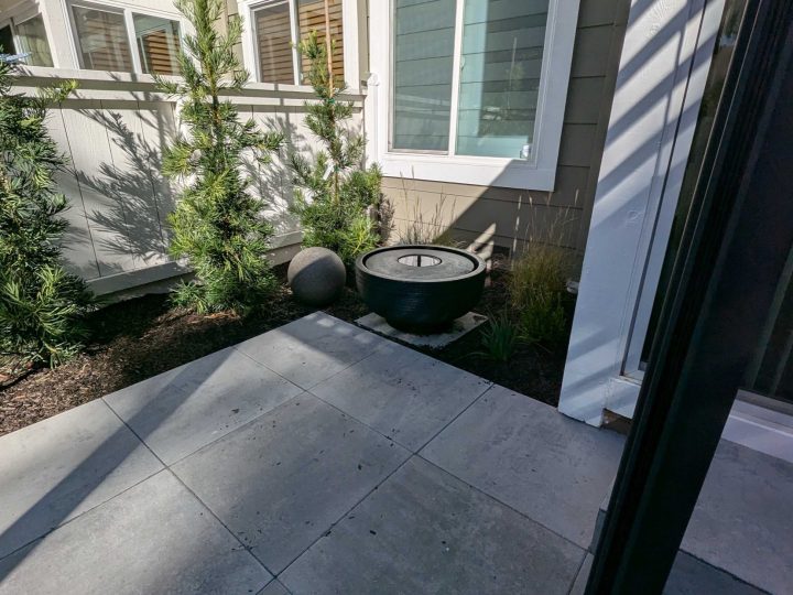 Pleasanton paver patio planting and privacy detail beside a black louvered patio cover by FG Pavers and Turf.